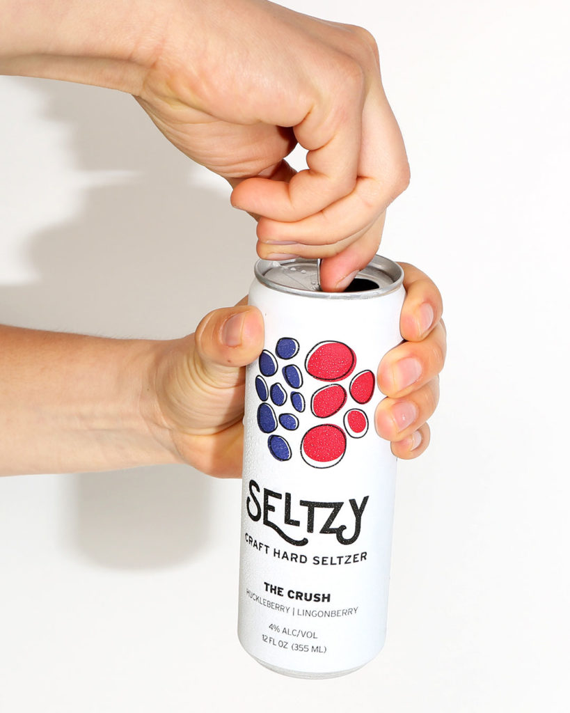 cracking open a can of Roadhouse seltzy hard seltzer