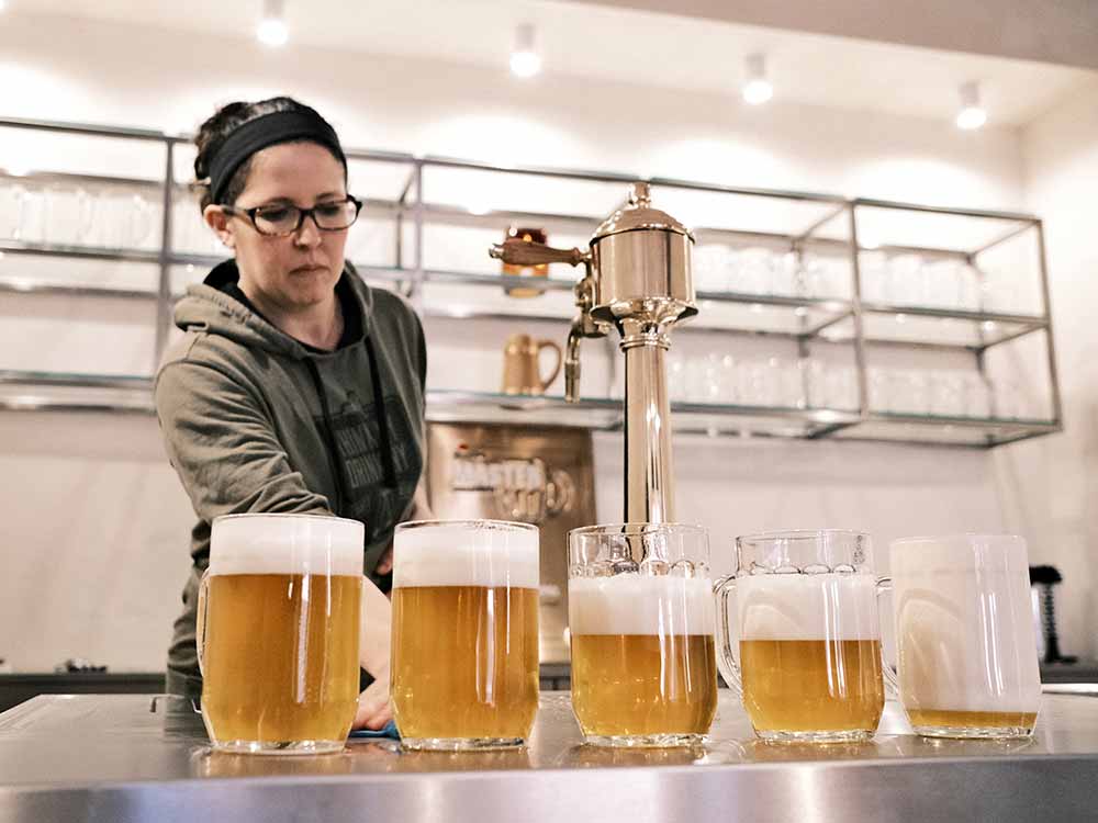 wild east brewing co-founder lindsay steen lukr czech pours hladinka, snyt, and mliko