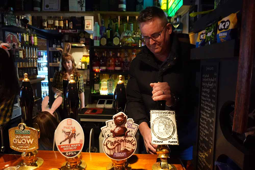 the tamworth tap co-founder george greenaway hand pulling otherworld medusa porter case ale